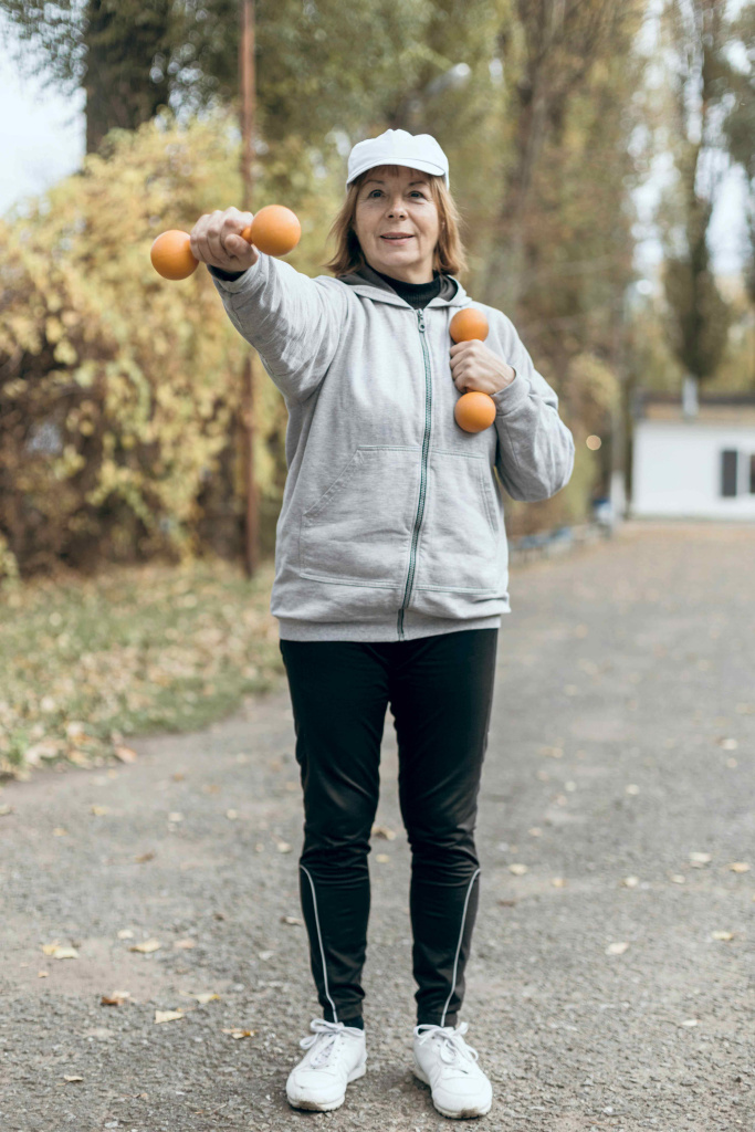 smiley-elderly-woman-working-out-with-weights-outside.jpg